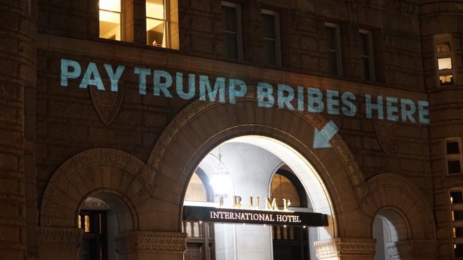 Protest slogan projected on Trump's hotel in Washington DC